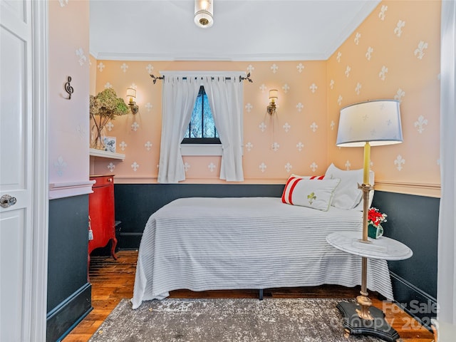 bedroom featuring hardwood / wood-style floors and ornamental molding