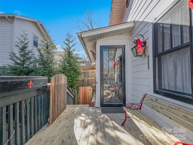 view of exterior entry featuring a wooden deck