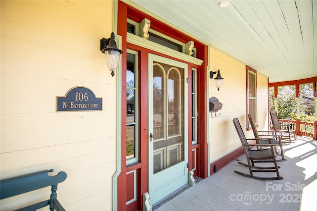 view of exterior entry with a porch