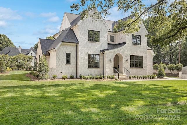 french provincial home featuring a front lawn