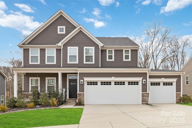 craftsman-style home with a garage and a front yard