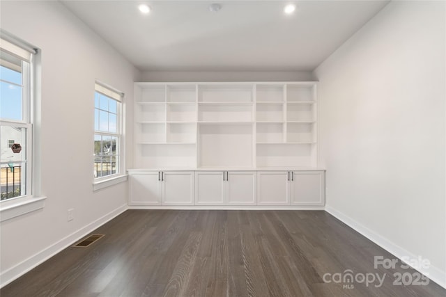 empty room with dark hardwood / wood-style flooring