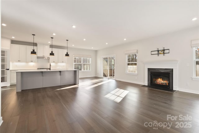 unfurnished living room featuring dark hardwood / wood-style floors