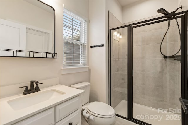 bathroom featuring vanity, toilet, and walk in shower