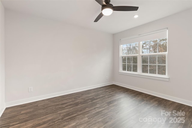 empty room with dark hardwood / wood-style flooring and ceiling fan