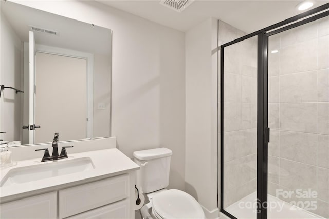 bathroom featuring walk in shower, vanity, and toilet