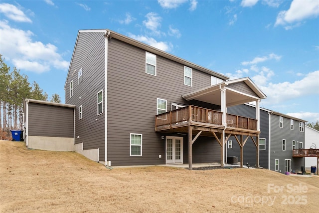 back of house with a wooden deck and central AC unit