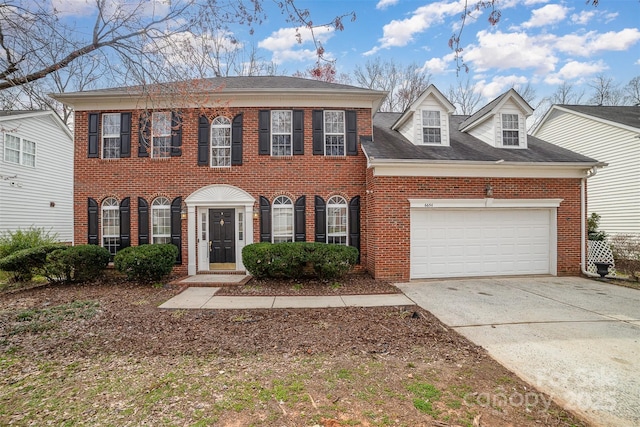 view of front of home with brick siding, concrete driveway, and an attached garage