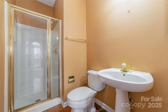 full bathroom featuring toilet and a shower stall