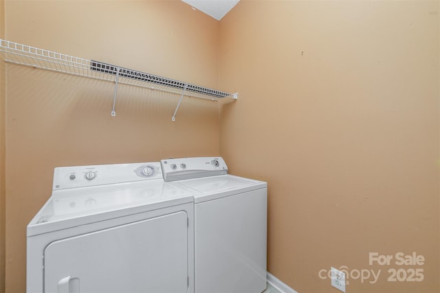 washroom featuring laundry area and washing machine and clothes dryer