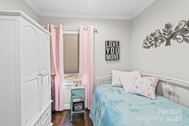 bedroom with crown molding and dark hardwood / wood-style flooring