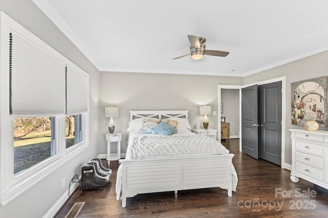 bedroom with dark hardwood / wood-style flooring, ceiling fan, and crown molding