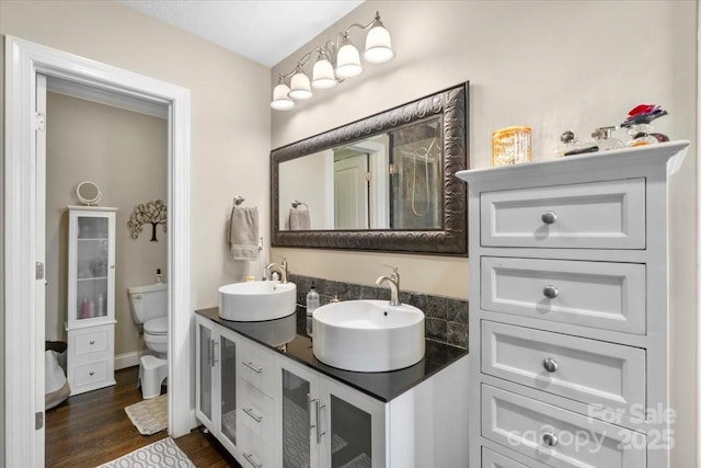 bathroom with hardwood / wood-style floors, vanity, and toilet