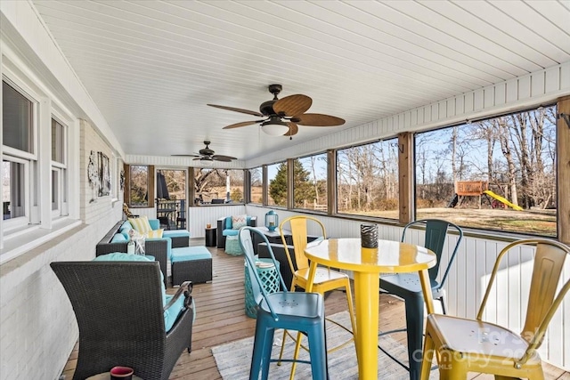 sunroom / solarium featuring ceiling fan