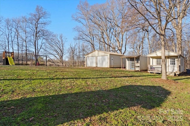 view of yard with a garage and an outdoor structure