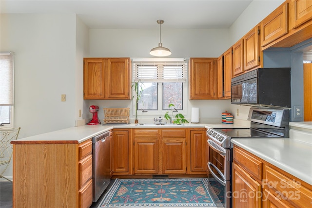 kitchen featuring hanging light fixtures, kitchen peninsula, sink, and stainless steel appliances