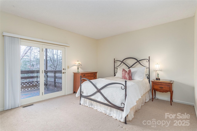 carpeted bedroom with access to outside