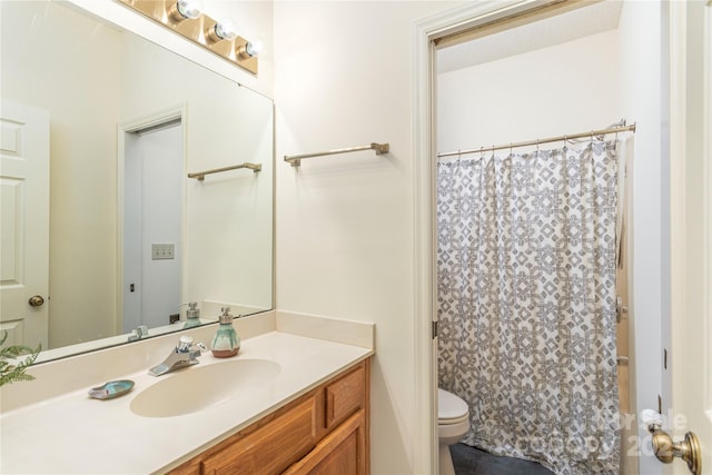 bathroom featuring toilet and vanity