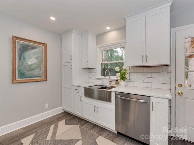 kitchen with dishwasher, decorative backsplash, and white cabinetry