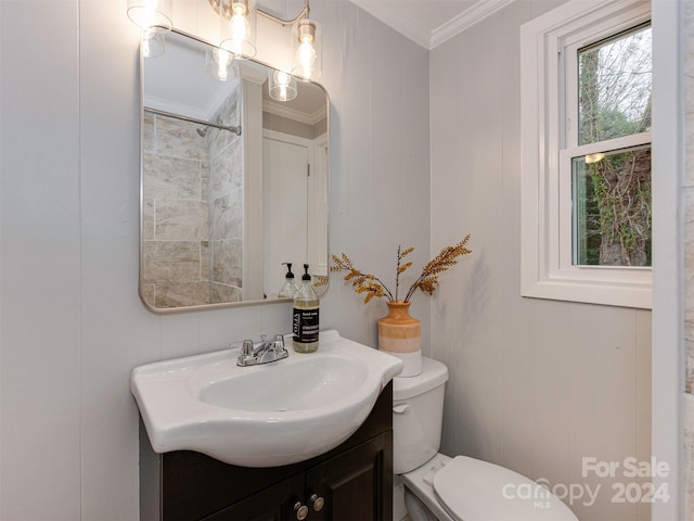 bathroom featuring vanity, toilet, and ornamental molding