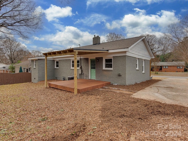 back of house featuring a deck