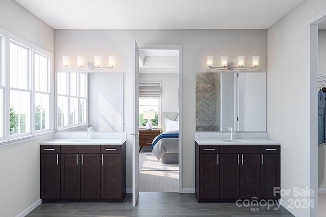 bathroom featuring a wealth of natural light, hardwood / wood-style floors, and vanity