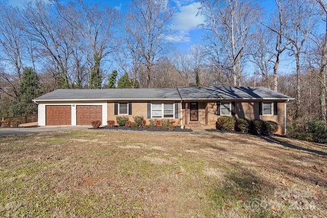 ranch-style house featuring a garage and a front yard