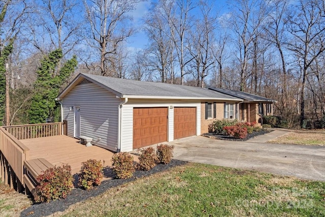 view of home's exterior with a garage and a wooden deck