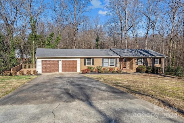 single story home featuring a front yard and a garage