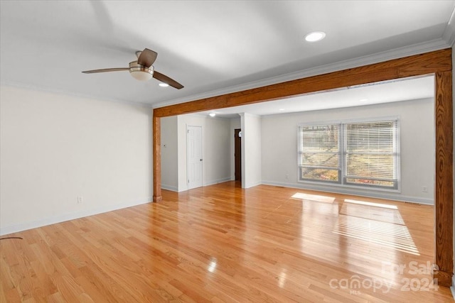 unfurnished room with crown molding, ceiling fan, and light wood-type flooring