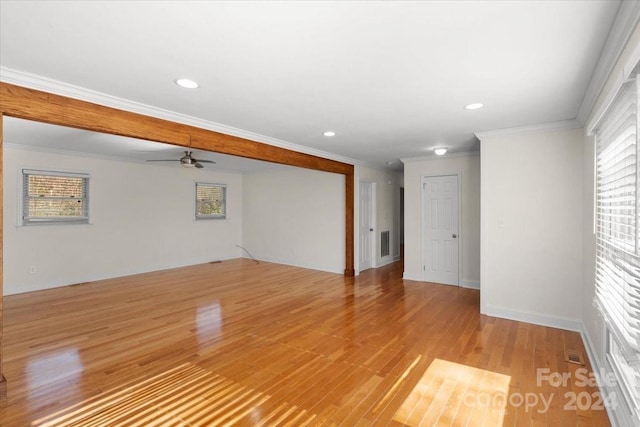 empty room with light hardwood / wood-style floors, ceiling fan, and ornamental molding