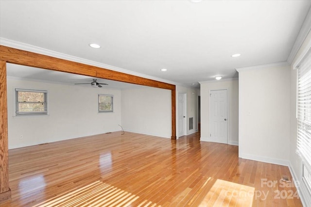 spare room featuring light hardwood / wood-style floors, ceiling fan, and ornamental molding