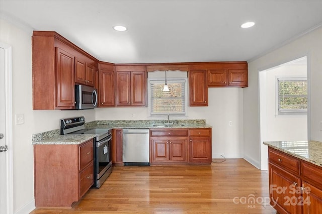 kitchen featuring crown molding, sink, light stone countertops, light hardwood / wood-style floors, and stainless steel appliances