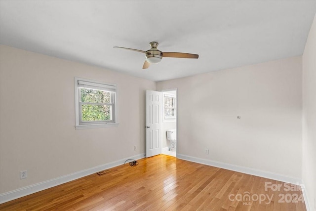 spare room with wood-type flooring and ceiling fan