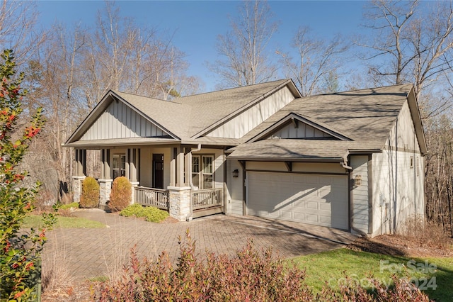 view of front of property with covered porch and a garage