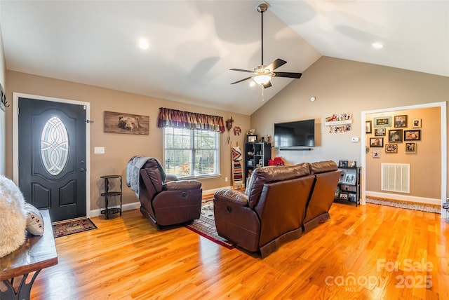 living room with ceiling fan, light hardwood / wood-style flooring, and lofted ceiling