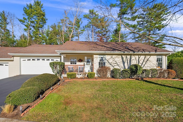 ranch-style house featuring a front yard, a porch, and a garage