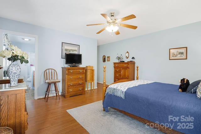 bedroom featuring ensuite bathroom, ceiling fan, and hardwood / wood-style flooring