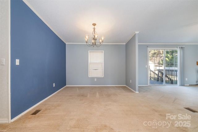 empty room featuring light carpet, ornamental molding, and a notable chandelier