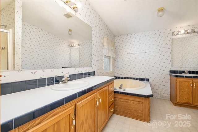 bathroom with tile patterned flooring, vanity, and separate shower and tub