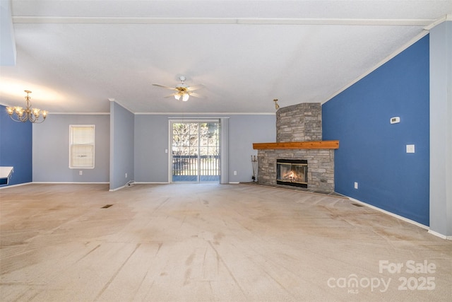 unfurnished living room featuring a fireplace, ceiling fan with notable chandelier, light colored carpet, and crown molding