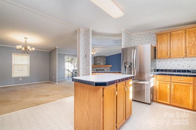 kitchen with light carpet, stainless steel fridge, ceiling fan with notable chandelier, crown molding, and a kitchen island