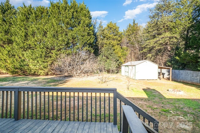 wooden terrace featuring a lawn and a shed