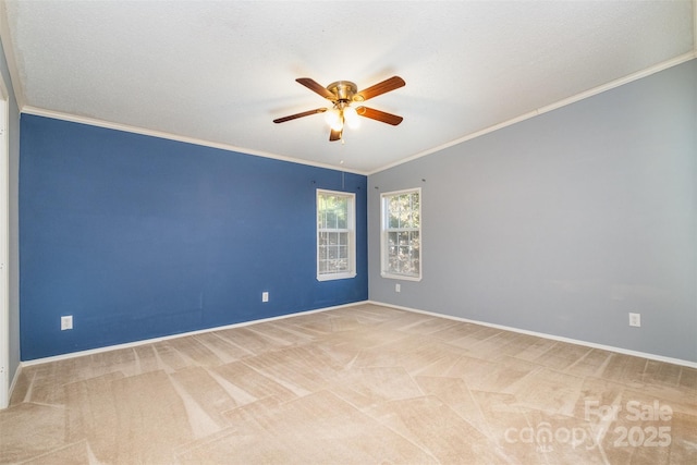 carpeted empty room featuring ceiling fan, ornamental molding, and lofted ceiling