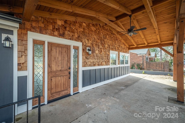 view of exterior entry featuring ceiling fan