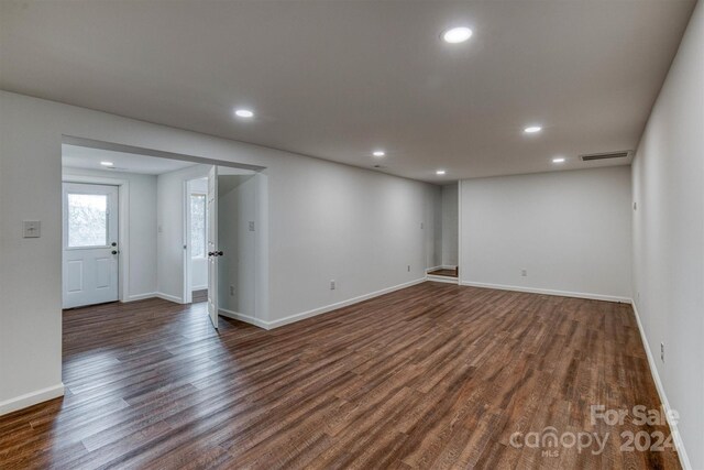 empty room with dark wood-type flooring