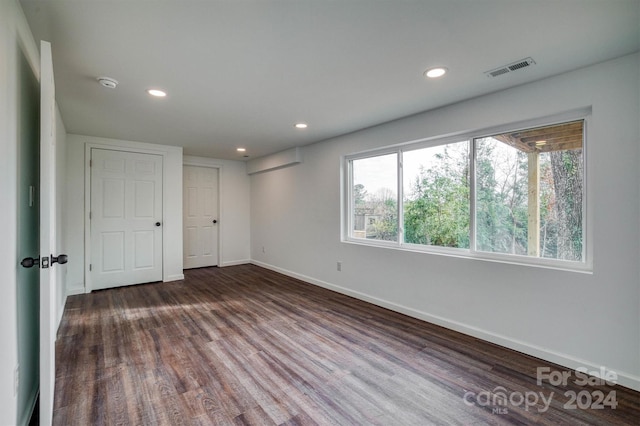 spare room with dark hardwood / wood-style flooring