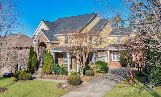 view of front facade featuring a front yard and a garage