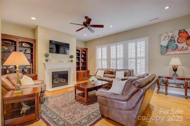 living room with ceiling fan and light hardwood / wood-style floors