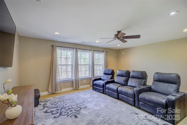 carpeted cinema room with ceiling fan